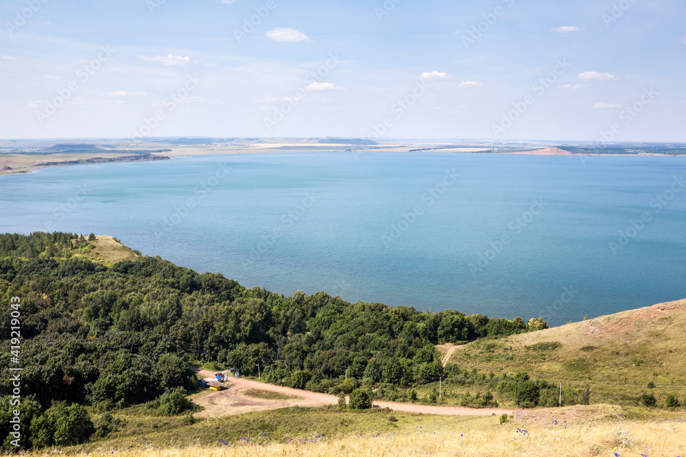 The largest Aslikul lake, karst and sinkhole, shore with hills. The Republic of Bashkortostan, Russia