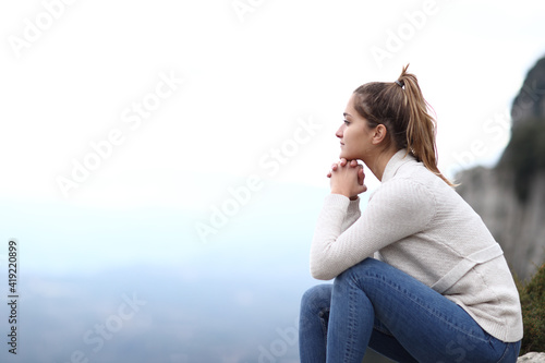 Happy woman contemplating views in the mountain