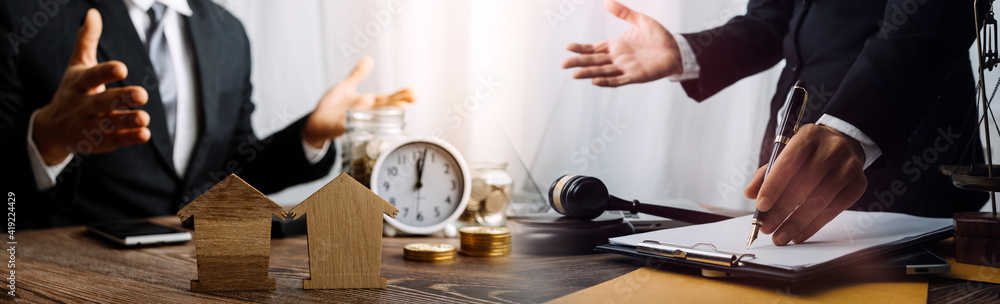 Business and lawyers discussing contract papers with brass scale on desk in office. Law, legal services, advice, justice and law concept picture with film grain effect Business and lawyers discussing contract papers with brass scale on desk in office. Law, legal services, advice, justice and law concept picture with film grain effect