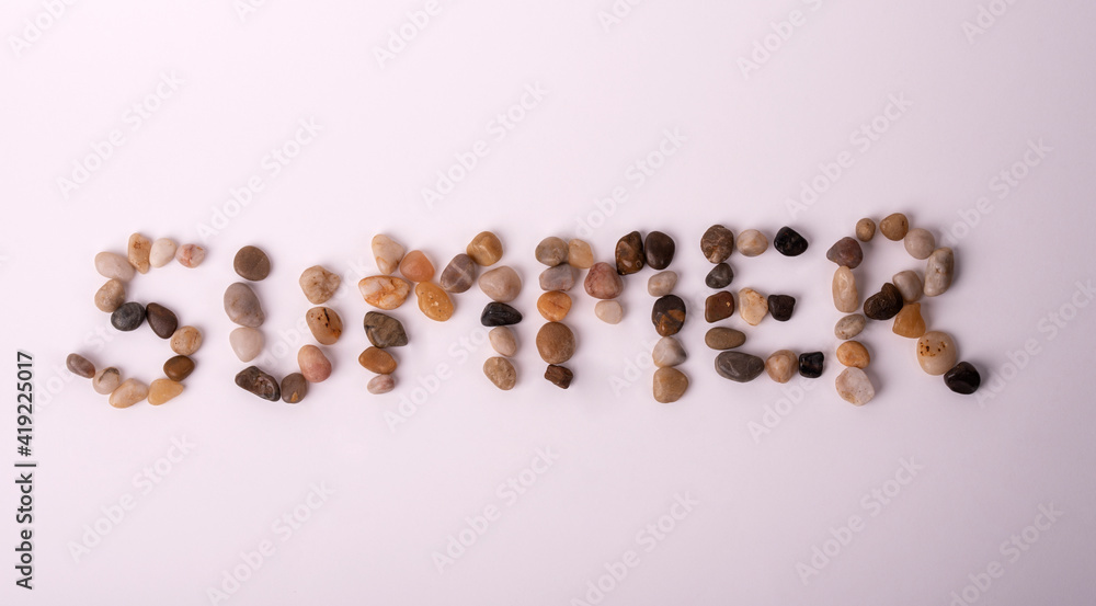 summer written with beach stones summer written with beach stones
