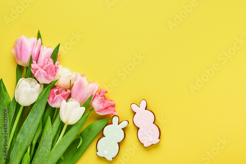 Pink tulip flowers bouquet on front of yellow background. Greeting card. With copy space. © kasia2003