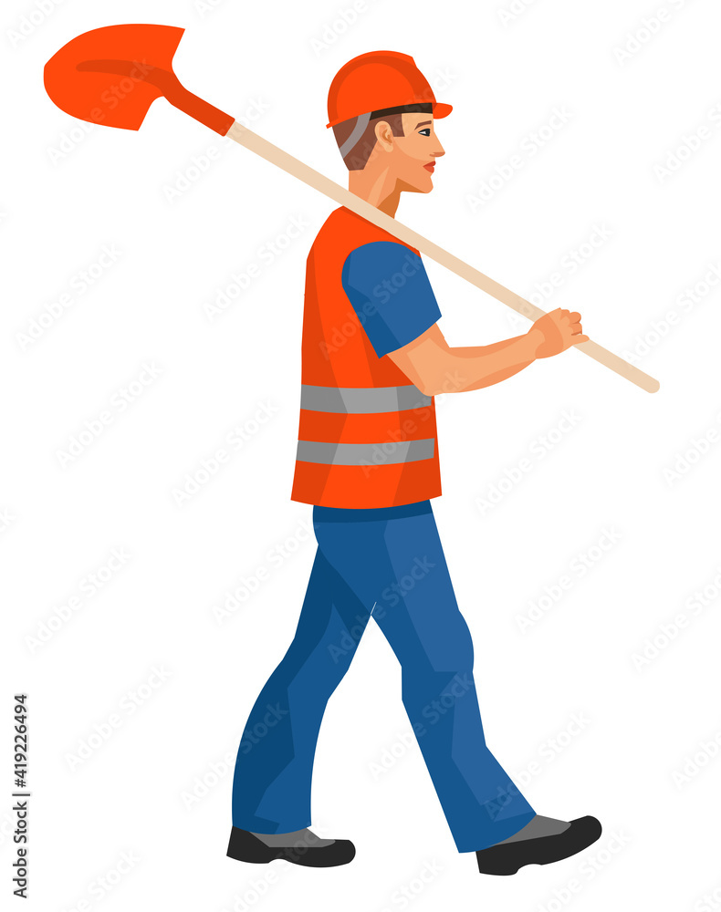 A worker in work clothes walks with a shovel on his shoulder A worker in work clothes walks with a shovel on his shoulder