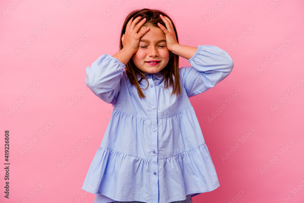 Little caucasian girl isolated on pink background laughs joyfully keeping hands on head. Happiness concept. Little caucasian girl isolated on pink background laughs joyfully keeping hands on head. Happiness concept.