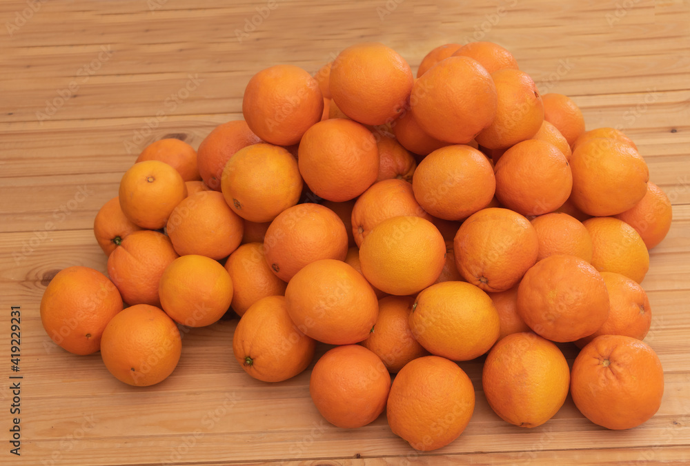 Lots of oranges on wooden background - benefits of oranges concept Lots of oranges on wooden background - benefits of oranges concept