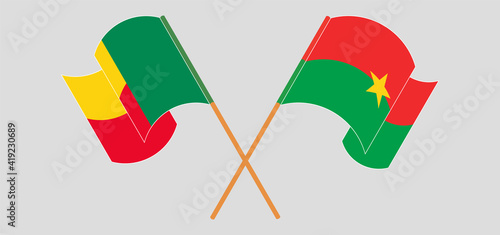 Crossed and waving flags of Benin and Burkina Faso