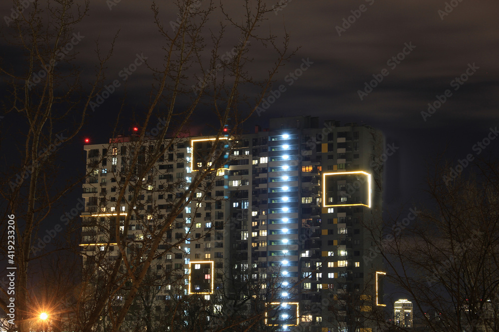 Fototapeta premium interesting unusual night illumination of a residential building