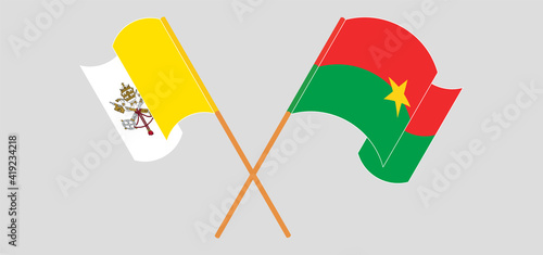 Crossed and waving flags of Vatican and Burkina Faso