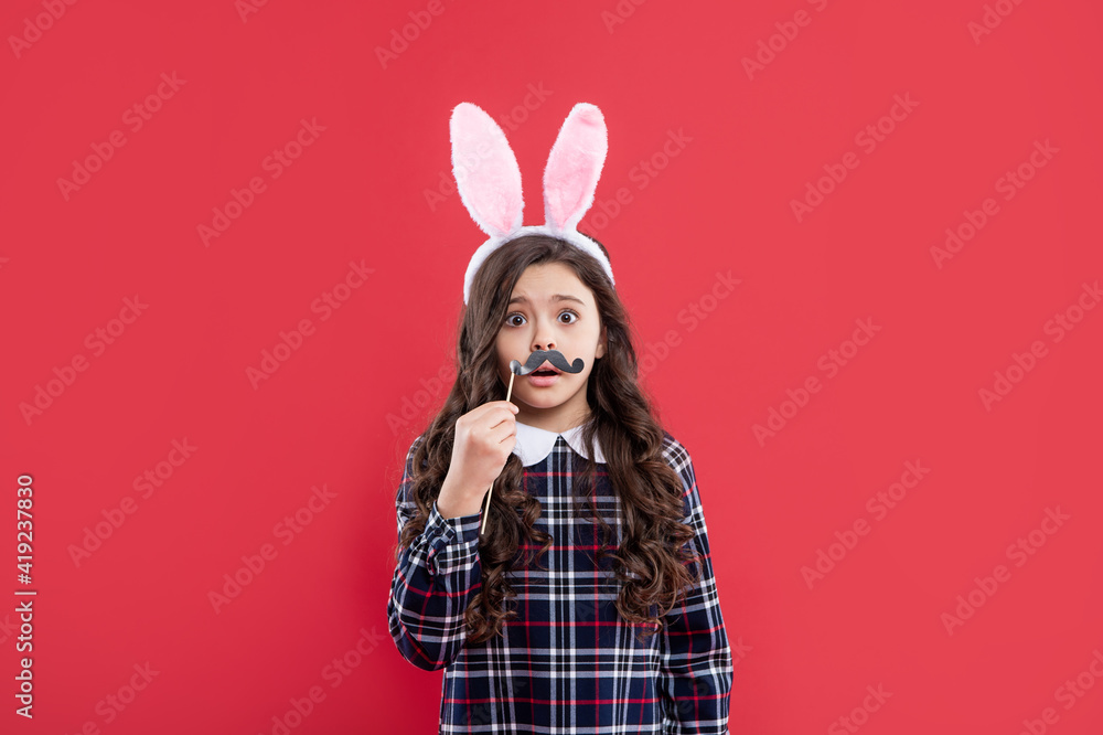 upset bunny kid with party moustache. happy easter holiday. funny child in hare ears. upset bunny kid with party moustache. happy easter holiday. funny child in hare ears.