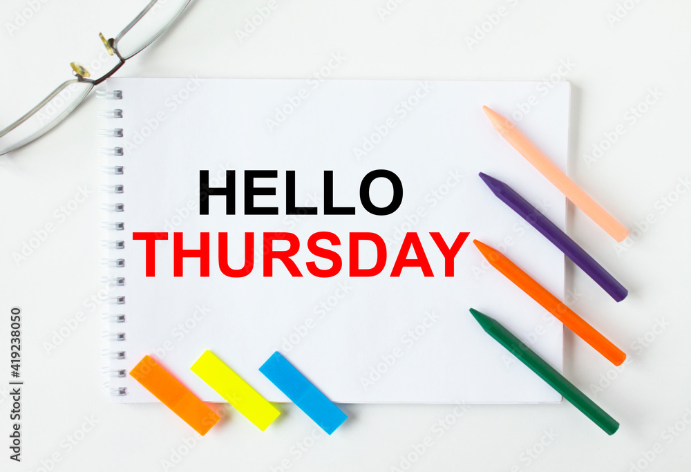 Notepad with text Hello Thursday glasses colored pencils and colored stickers Notepad with text Hello Thursday glasses colored pencils and colored stickers