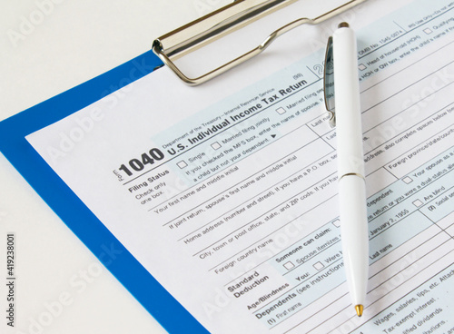 USA tax form 1040 with eyeglasses and Pen on a clip board