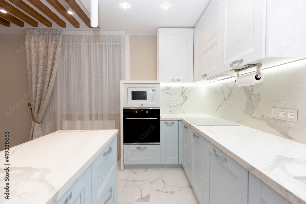 Beautiful white kitchen with black stove. Beautiful white kitchen with black stove.