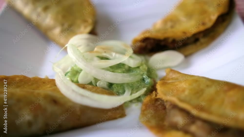 Mexican basket tacos and onion slices on white plate Mexican basket tacos and onion slices on white plate
