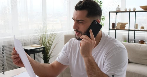 Shot of a man having a phone call while working at home