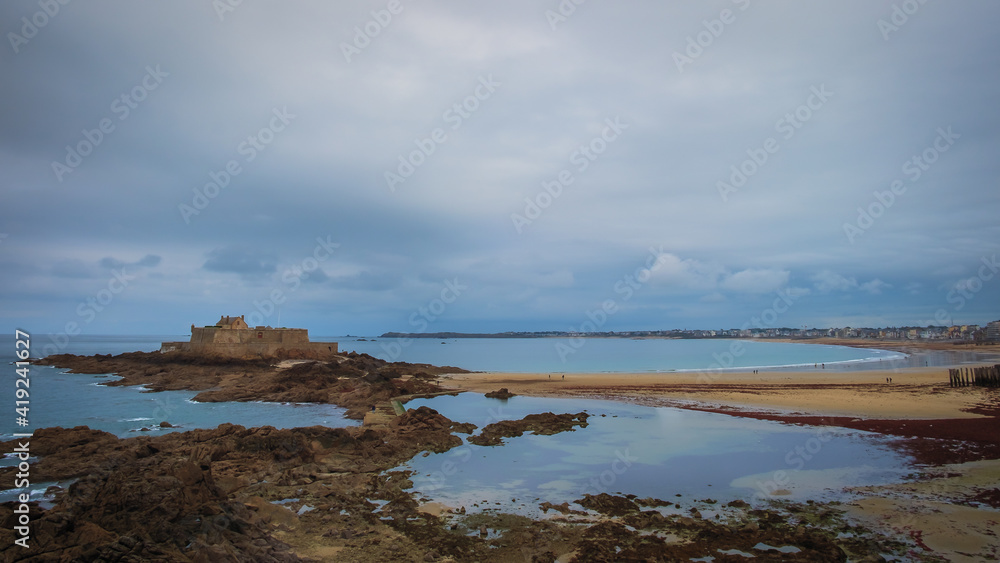 View of Bon-Secours beach and Grand Bé a tidal island near the coast of St-Malo, France View of Bon-Secours beach and Grand Bé a tidal island near the coast of St-Malo, France