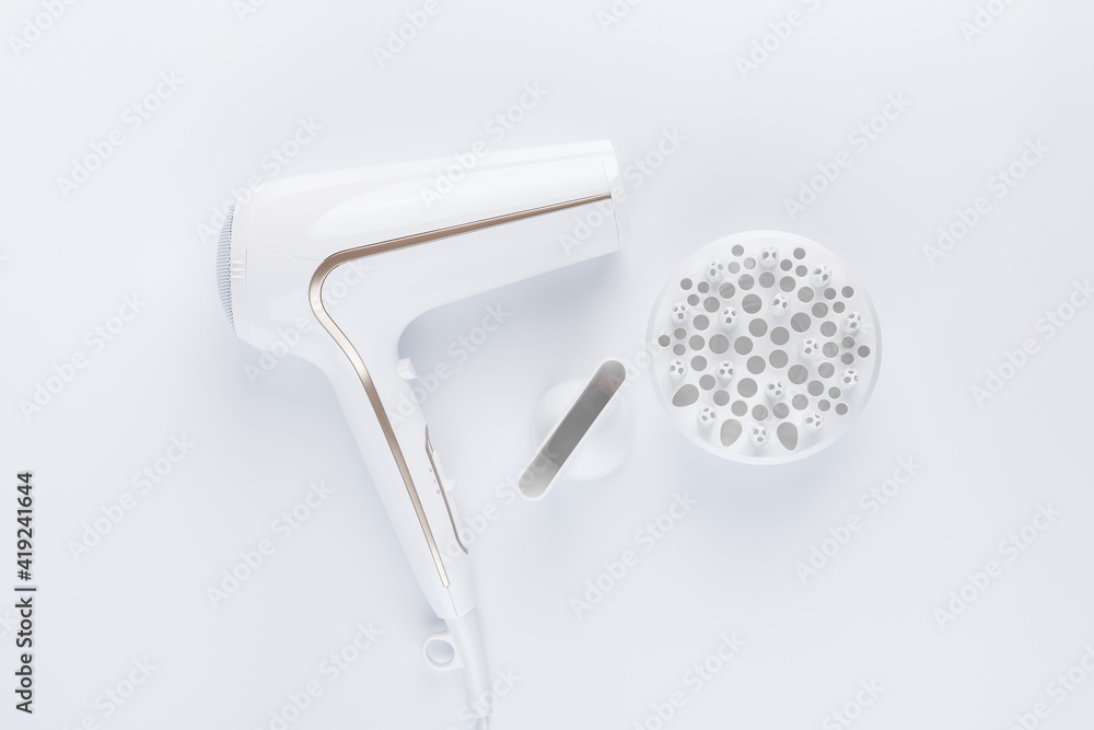 Hairdryer for drying hair with a diffuse and flat nozzle for styling on a white background Hairdryer for drying hair with a diffuse and flat nozzle for styling on a white background
