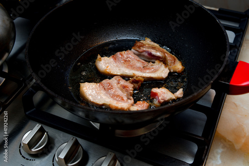 The loin of pork tenderloin is fried in a pan.