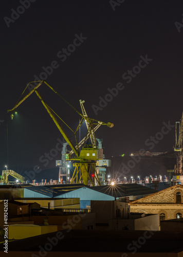 Busy cranes in port during the night shift