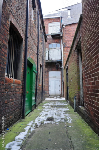 Narrow  old alleyway in the city during winter 