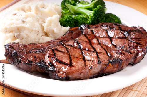bbq rib steak with garlic mashed potatoes and brocolli photo