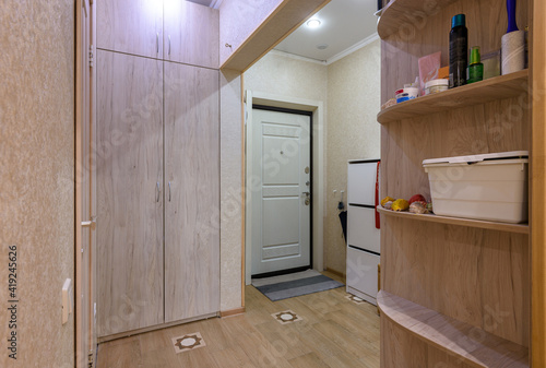 Interior of a classic hallway room with a large wardrobe in a studio apartment