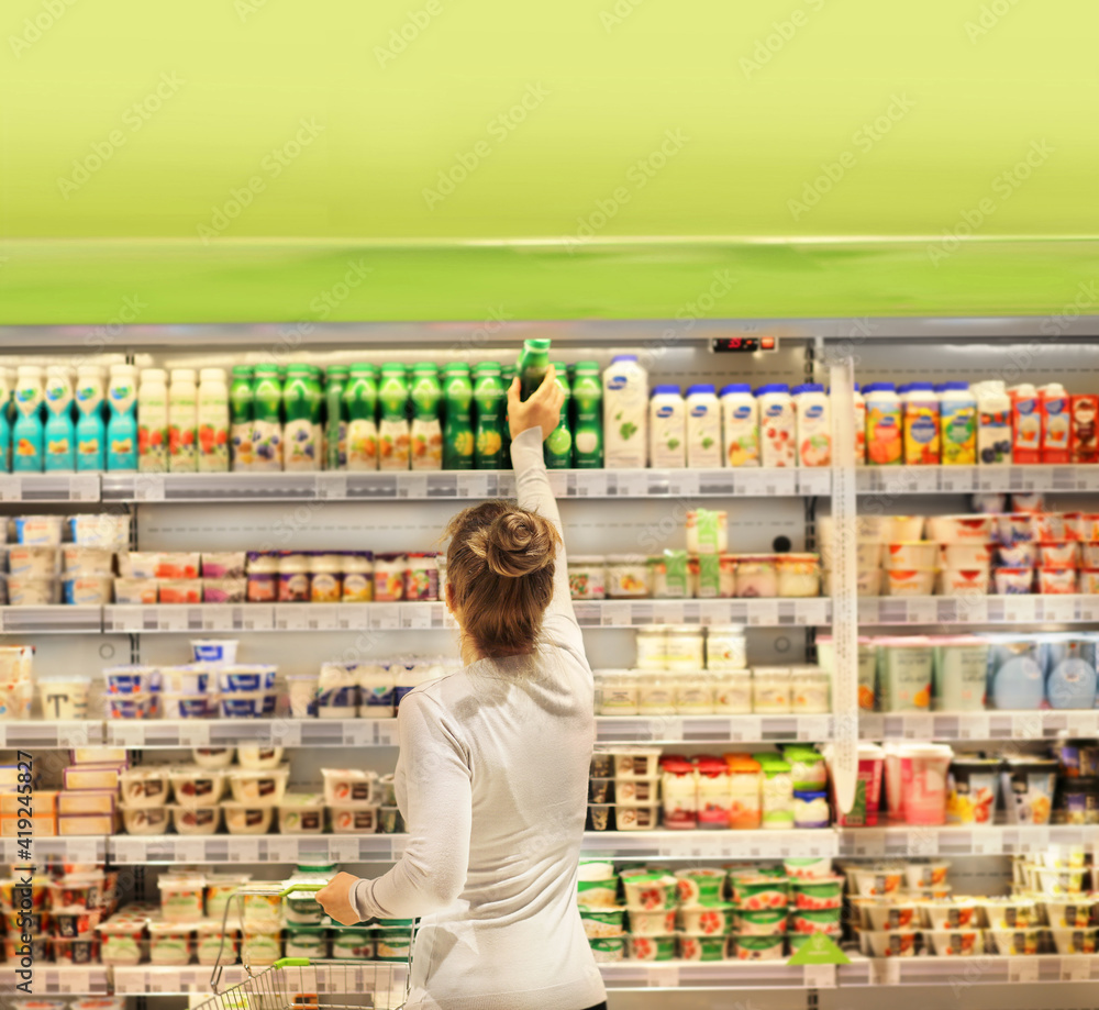 Woman choosing a dairy products at supermarket