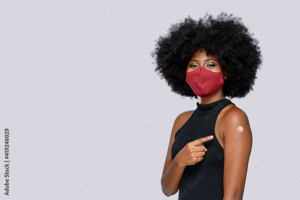 afro teenager girl happily shows the vaccine band aid afro teenager girl happily shows the vaccine band aid