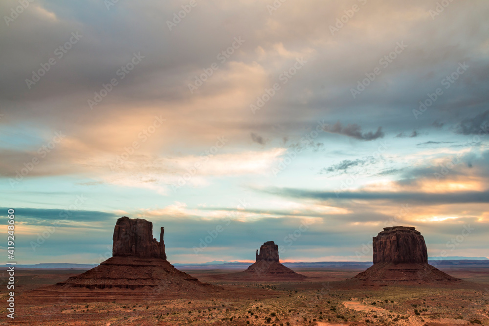 dramatic landscape photo of the spectacular mesa and buttes and rock formations in Monument Valley in the border of Utah and Arizona.