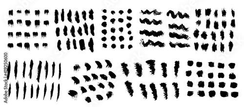 Vector set of freehand brush strokes and stains. Abstract black elements, isolated on white background. Ink splashes with grunge texture.