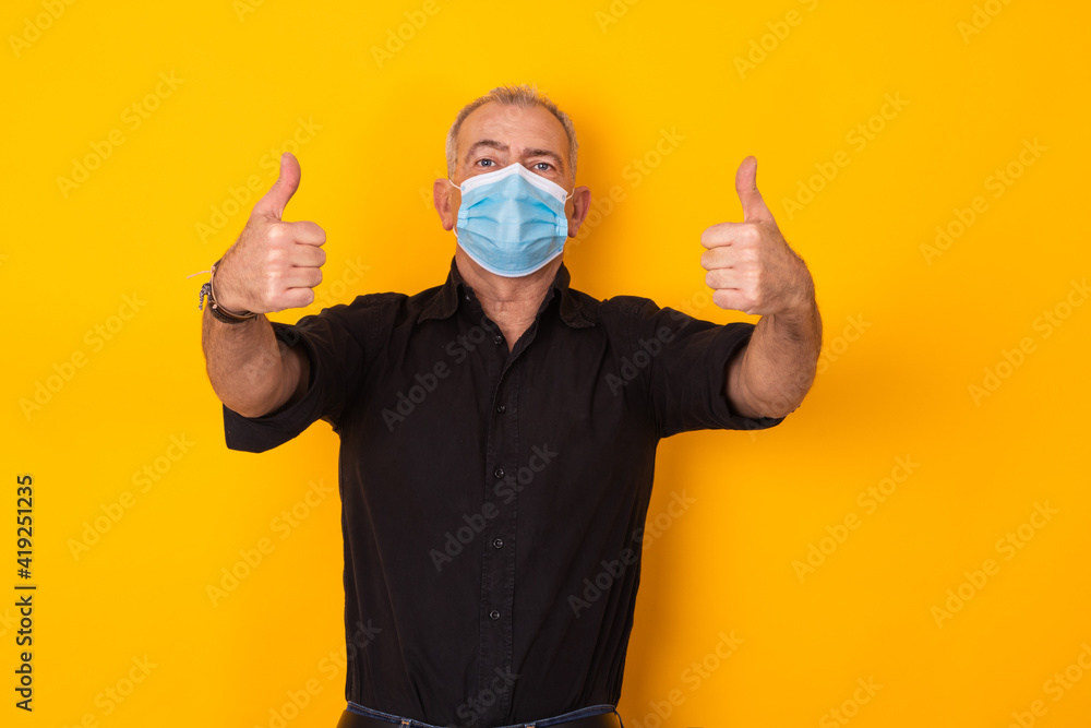 adult man with mask isolated with sign of approval and okay