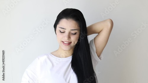 Isolated portrait of a beautiful young woman comb long hair	