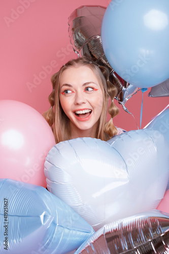 Woman smiles with balloons