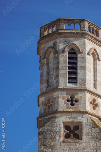 Medieval architecture. Detail of a tower of a castle from stone over the blue sky in the daytime.