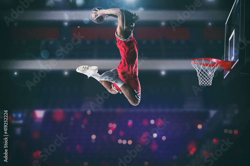 Foto Basketball game with a high jump player to make a slam dunk to the basket