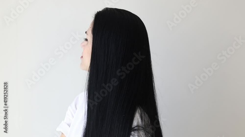 Isolated portrait of a beautiful young woman comb long hair	