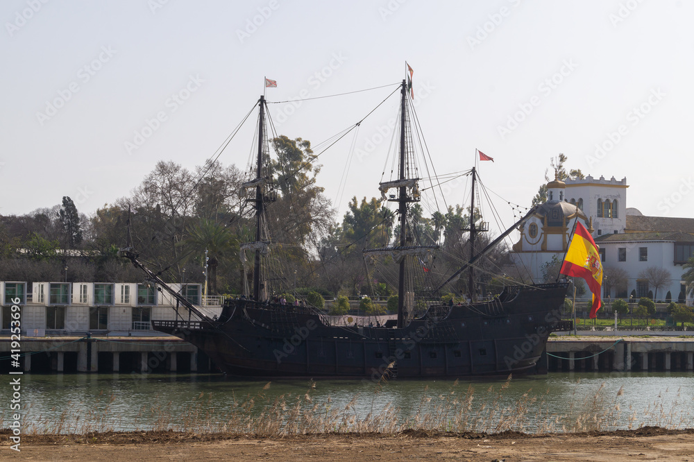 Replica of the Spanish galleon that traveled and discovered America for the first time. Old ship moored at a jetty on the Guadalquivir river in Seville (Andalusia, Spain). Replica of the Spanish galleon that traveled and discovered America for the first time. Old ship moored at a jetty on the Guadalquivir river in Seville (Andalusia, Spain).