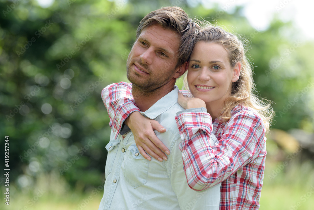 Fototapeta premium cheerfully couple hugging in park