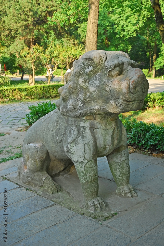 China, Nanjing, stone lion in the Sacred Way to Xiao ling Mausoleum. The place has harmony and serenity atmosphere. China, Nanjing, stone lion in the Sacred Way to Xiao ling Mausoleum. The place has harmony and serenity atmosphere.