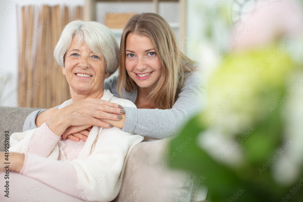 happy beautiful older mother and adult daughter looking at camera happy beautiful older mother and adult daughter looking at camera