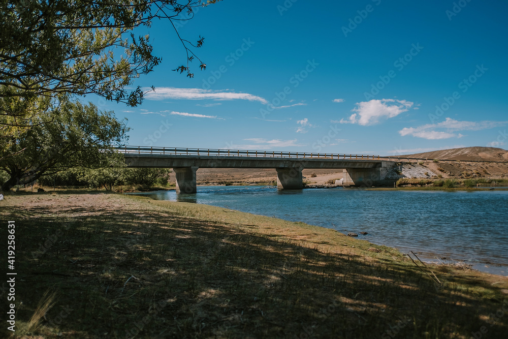 View of a large concrete bridge from below.
