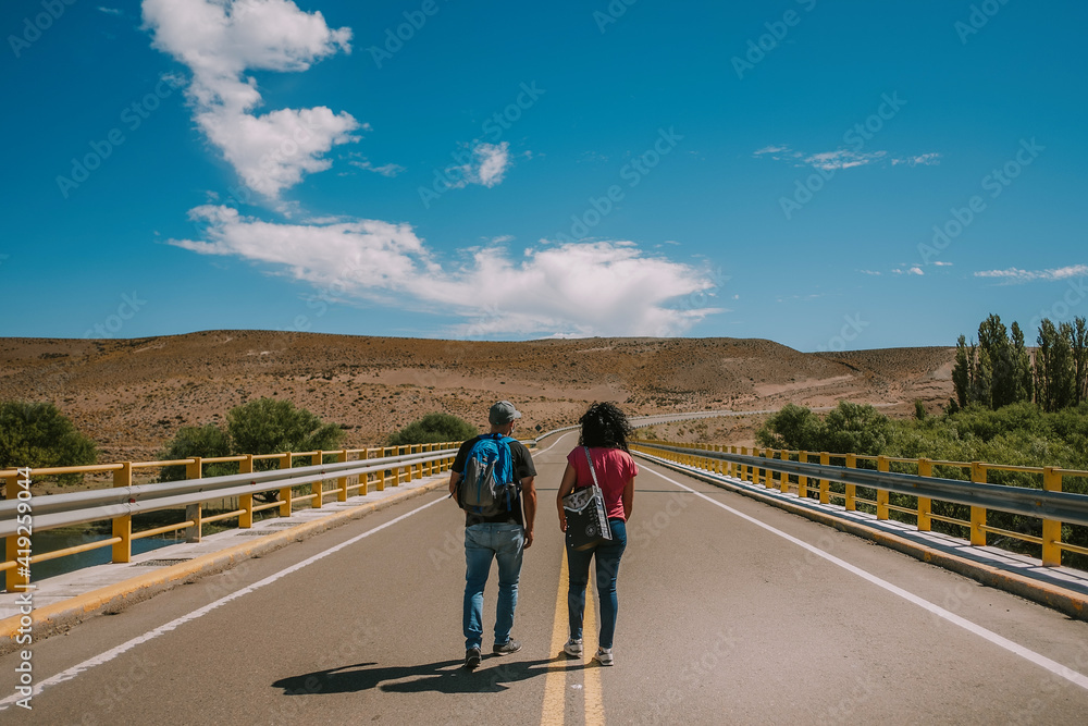 Fototapeta premium Traveler couple with backpack walking on route in Patagonia Argentina