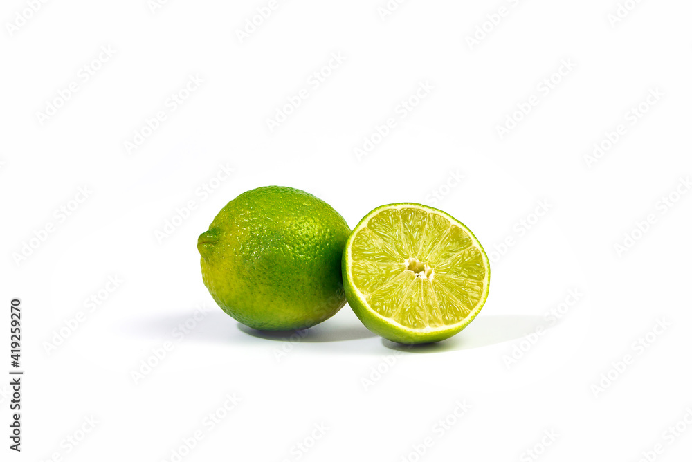 Whole lime and halfe of lime fruit close up with selective focus, isolated on white background with clipping path Whole lime and halfe of lime fruit close up with selective focus, isolated on white background with clipping path