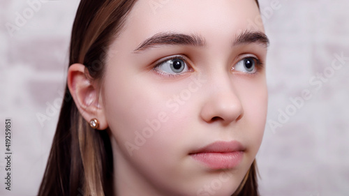 young cute girl with big light blue eyes, focus on the right eye