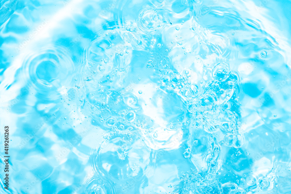 Obraz premium Pool, hot tub water background. Ripples on bright blue transparent water in swimming pool with light reflection. Top view