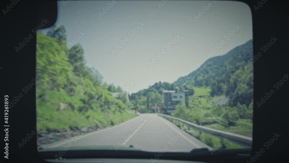 View of the road from a moving car. Point of view driving, first person. Vintage Film Look. 