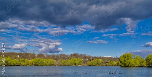 Spring rural landscape  field  landscape with clouds and sky  landscape with lake