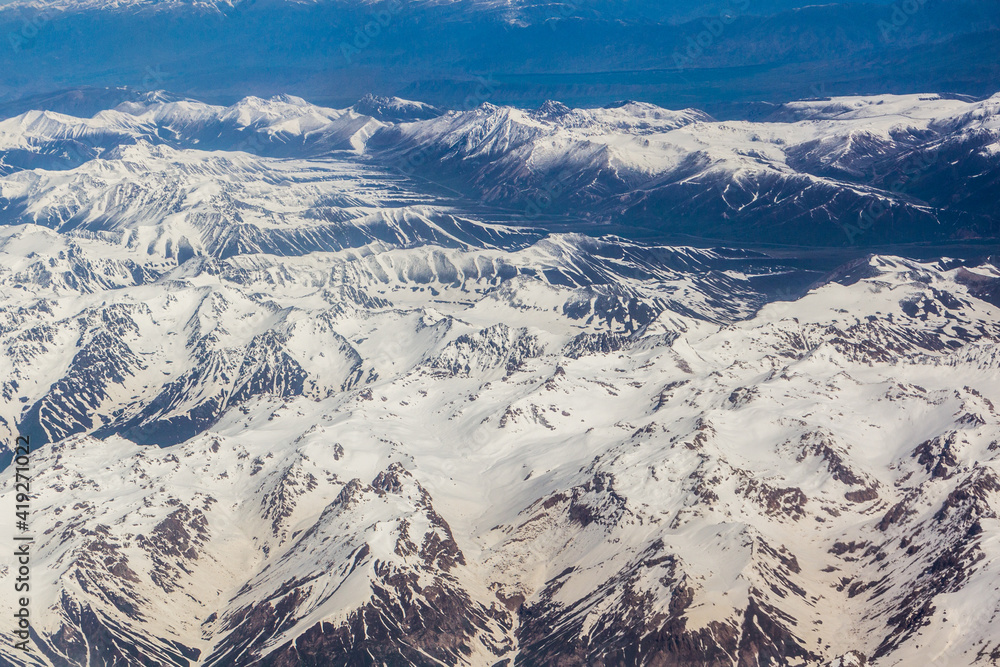 Fototapeta premium Aerial view of snow covered Tian Shan mountains in Kyrgyzstan