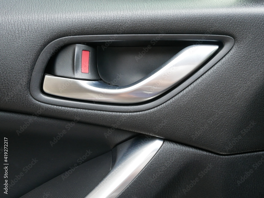 closeup of car door handle inside a car,car interior.