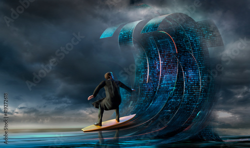 Businessman surfing binary code waves photo