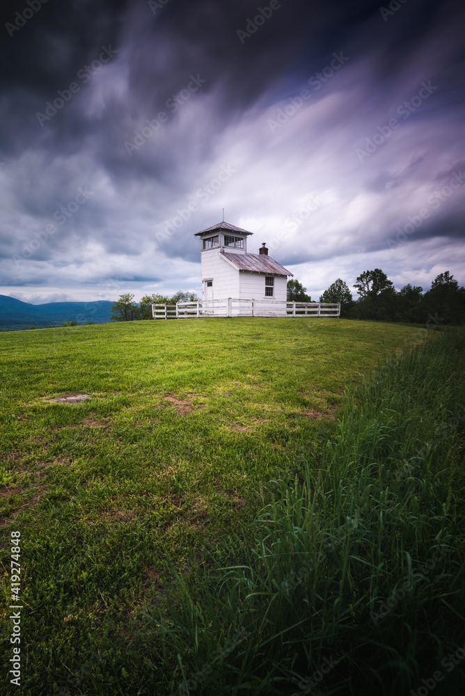 An old fire watchtower atop the foothills of Shenandoah National Park on a cloudy afternoon Summer day.