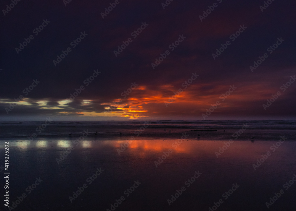 dramatic sunset reflected onto the sand